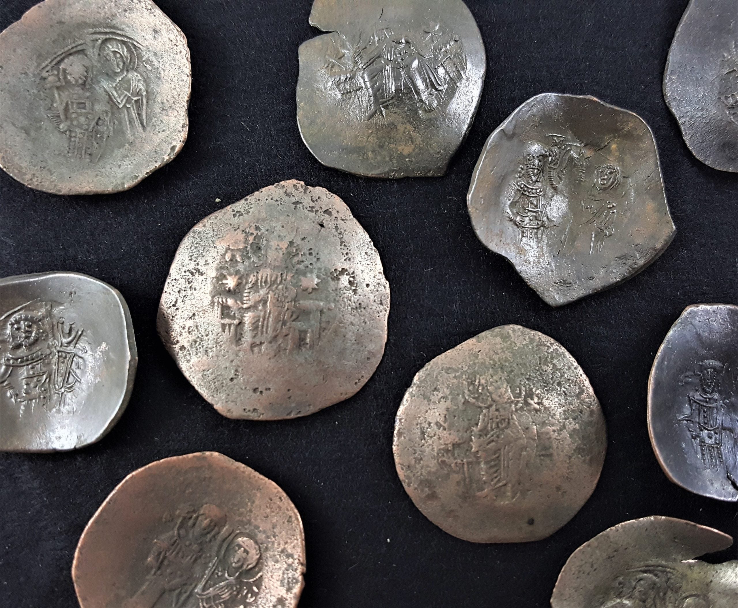 Cup-shaped bronze coins depicting Jesus Christ on the obvers and various other figures on the reverse. Struck over several centuries, from the 1100s-1400s.(C)